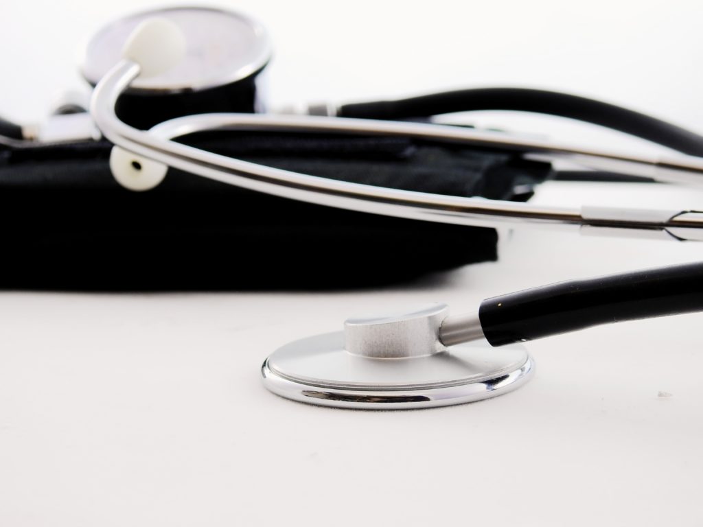 A stethoscope and a medical bag on a white background.