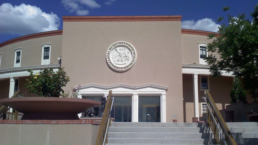 A tan building with stairs leading up to it.