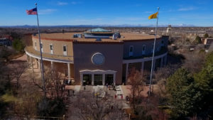 An aerial view of a building with flags flying over it.