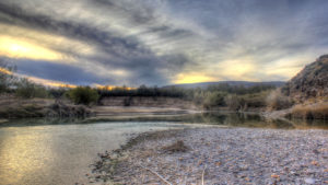 A cloudy sky over a river.