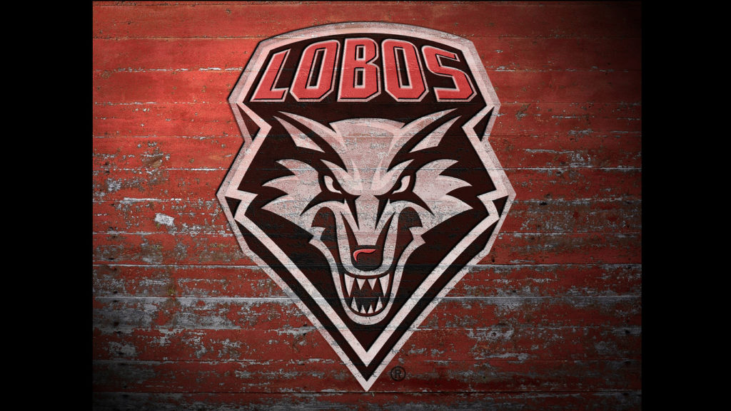 The lobos logo on a red brick wall.