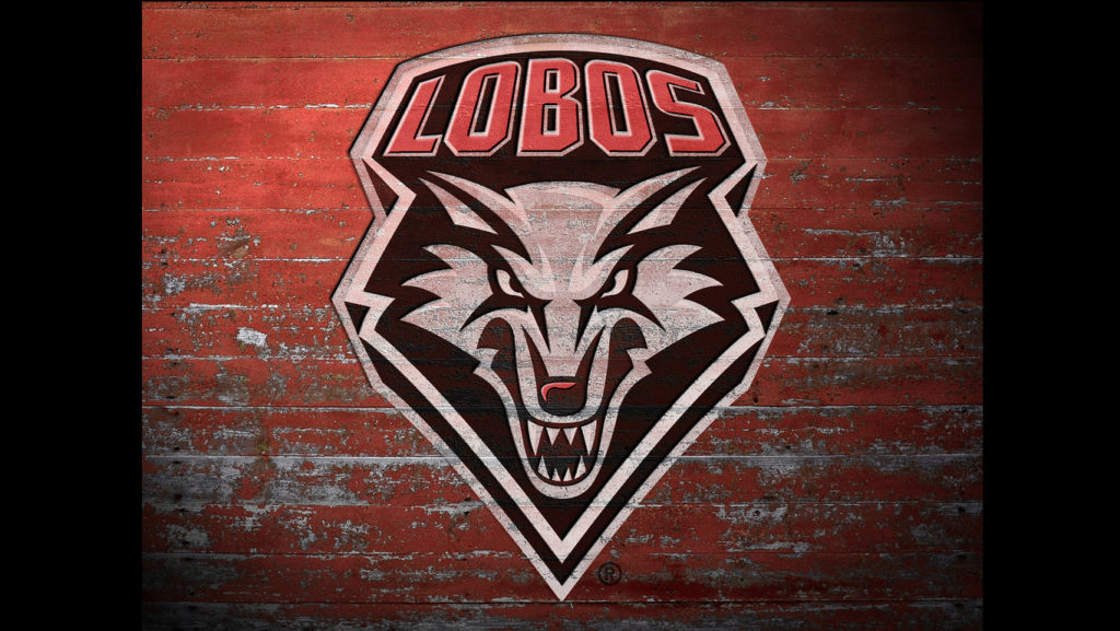 The lobos logo on a red brick wall.