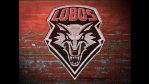 The lobos logo on a red brick wall.