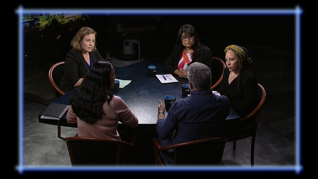 A group of people sitting around a table.