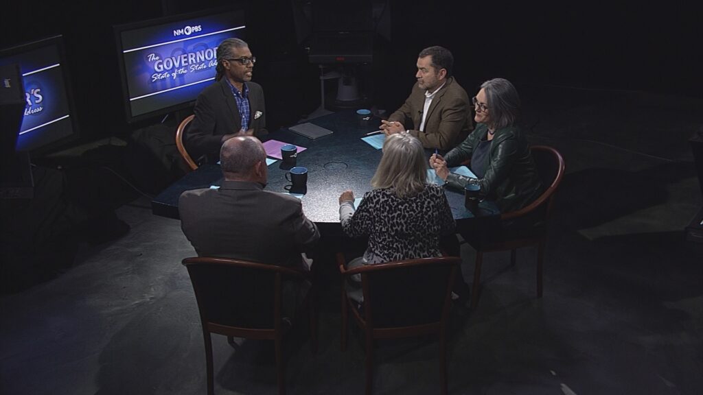 Gene Grant and the Line discuss with each other at a triangular table.