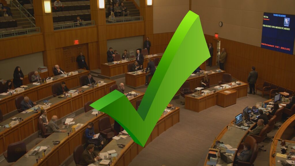 Composite of an illustrated checkmark in front of image of the Santa Fe Roundhouse interior.