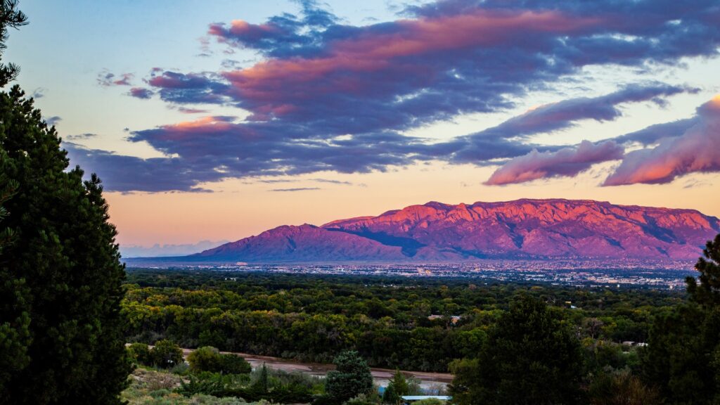 Far view of the Sandia mountains at sunset, with the city lurking below.