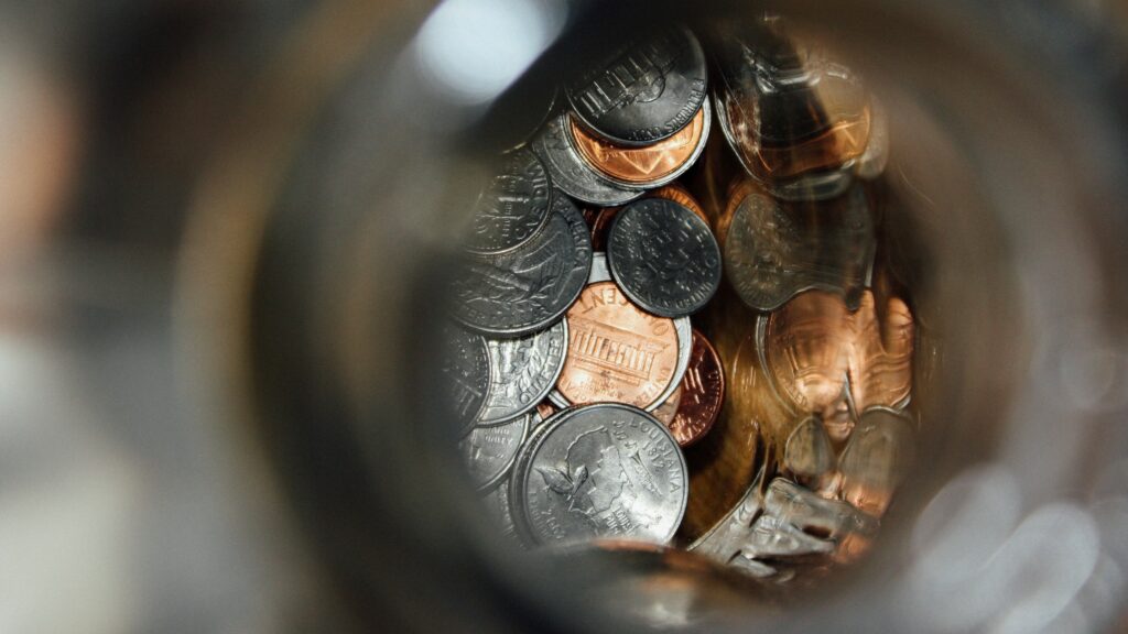 Close-up of a collection of U.S. coins in a jar.