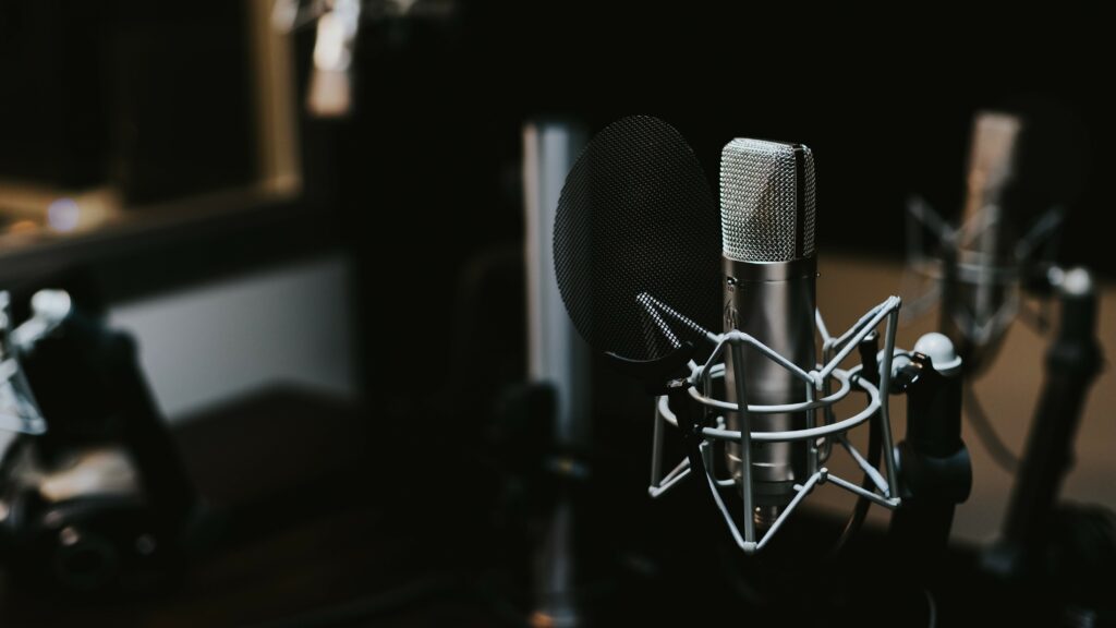 A recording booth with a couple of microphones in it.