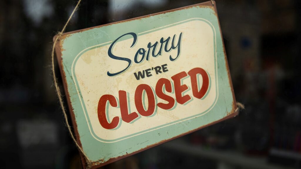 A storefront with sign reading "Sorry we're closed".