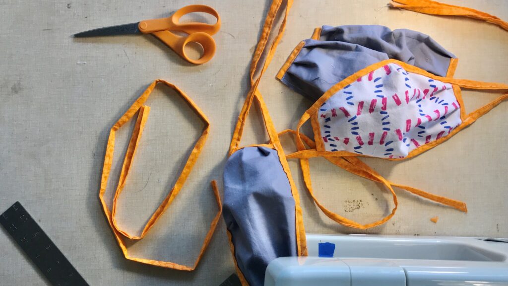 Overhead view of a variety of makeshift facemasks on a surface.