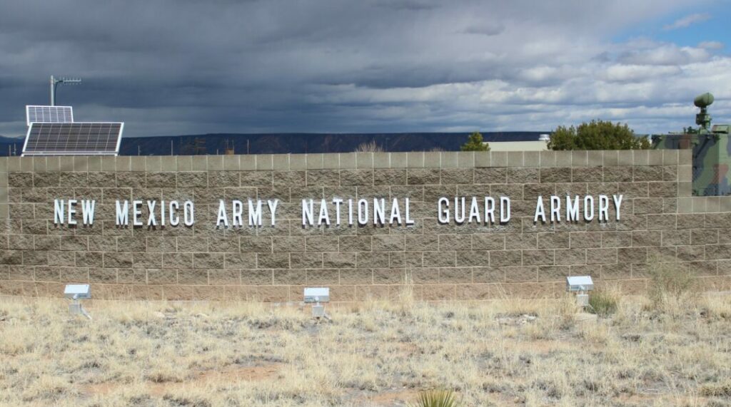 A brick wall with text reading "NEW MEXICO ARMY NATIONAL GUARD ARMORY".