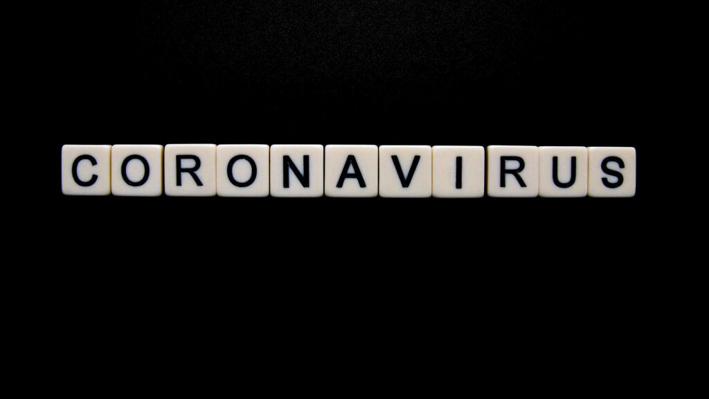 The word "CORONAVIRUS" spelled out with Scrabble tiles.