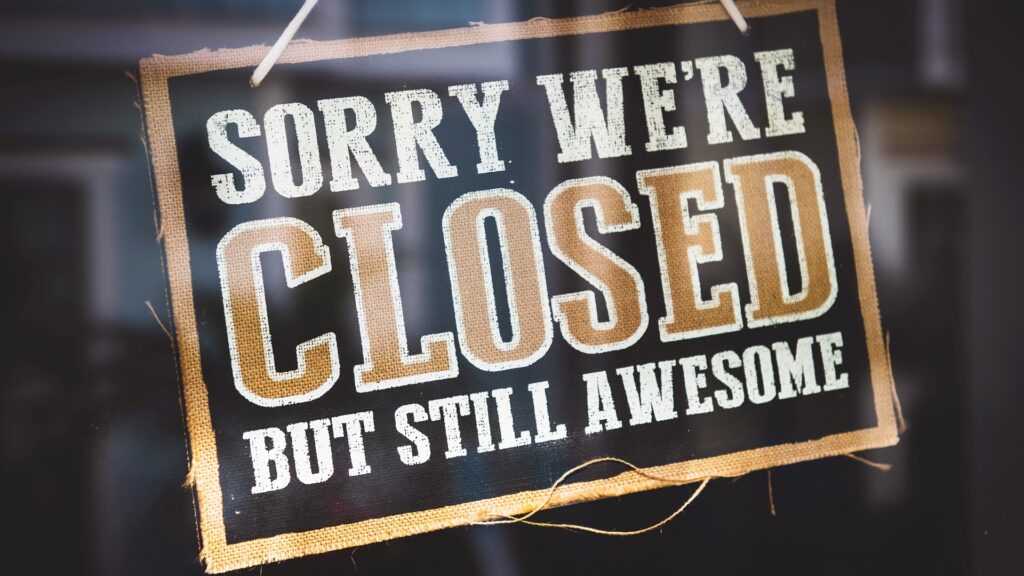 Storefront with a sign reading "SORRY WE'RE CLOSED BUT STILL AWESOME".