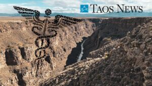 Composite of a caduceus symbol, logo for Taos News, and a rocky cliff in the background.