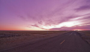 A purple sunset viewed with a very far vanishing point.