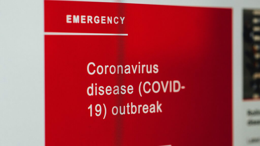 A bright red label reading "EMERGENCY: Coronavirus disease (COVID-19) outbreak" in plain text.