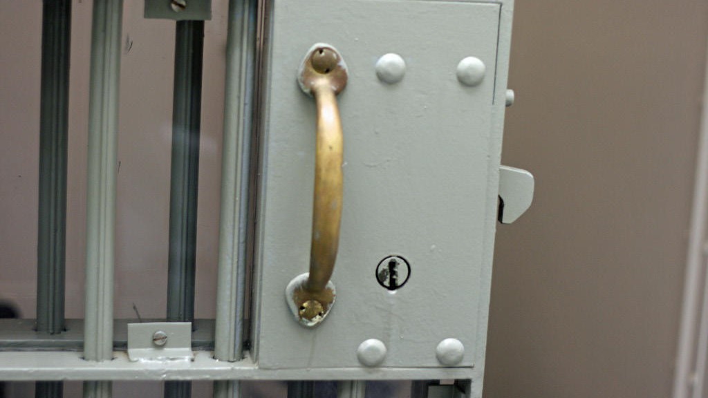 Close-up of a handle on a jail cell.