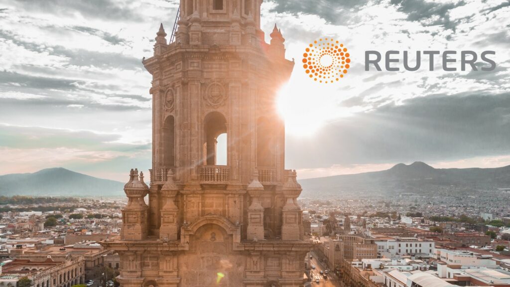 Composite of a tall cathedral, and superimposed logo for Reuters.