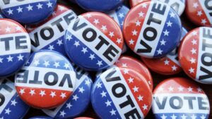 A group of red, white, and blue buttons reading "VOTE".