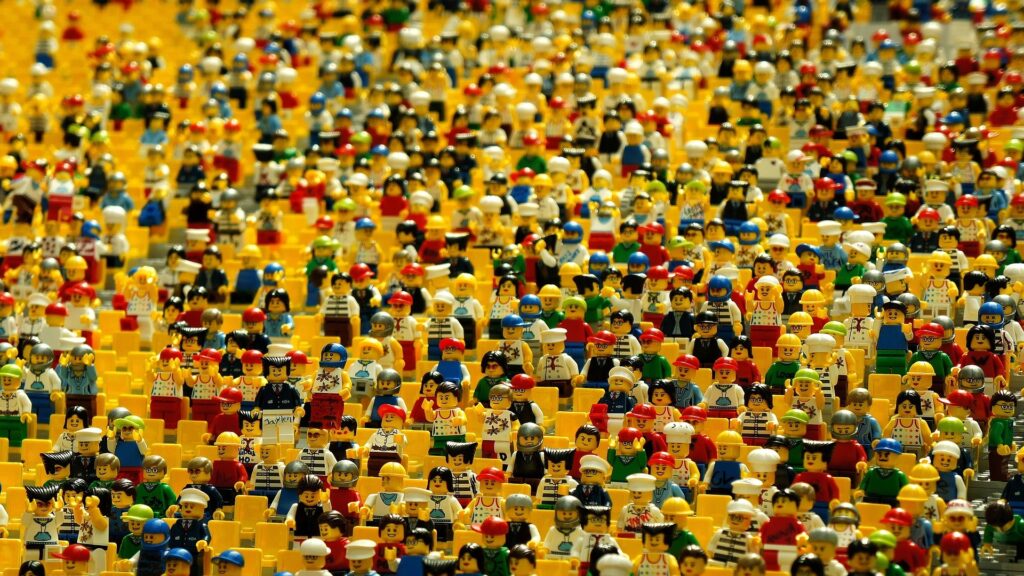 Dozens of Lego minifigures huddled together in a Lego theater.