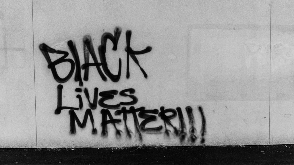 Graffiti on a wall reading "BLACK LIVES MATTER!!!"