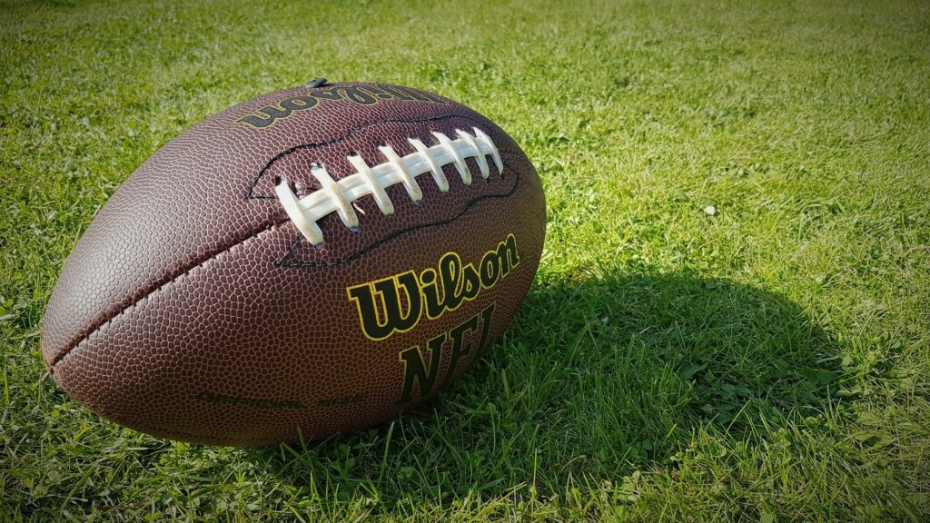 A football sits on grass.