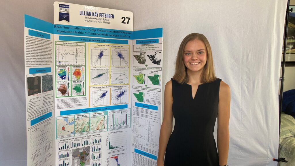 Regeneron Science Talent Search Winner Lillian Petersen poses in front of their report.