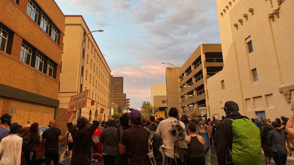 Demonstrators march in Downtown Albuquerque, protesting the deployment of federal agents by President Donald Trump.