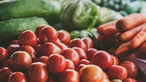 A collection of produce including tomatoes, carrots, lettuce, and more.