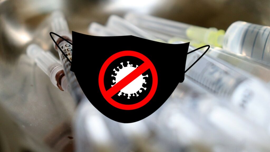 Composite of a crossed-out coronavirus printed onto a facemask, in front of an array of syringes.