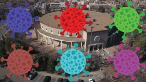 Composite of illustrated coronaviruses in front of the Santa Fe Roundhouse.