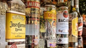 An array of liquor bottles stand next to each other.