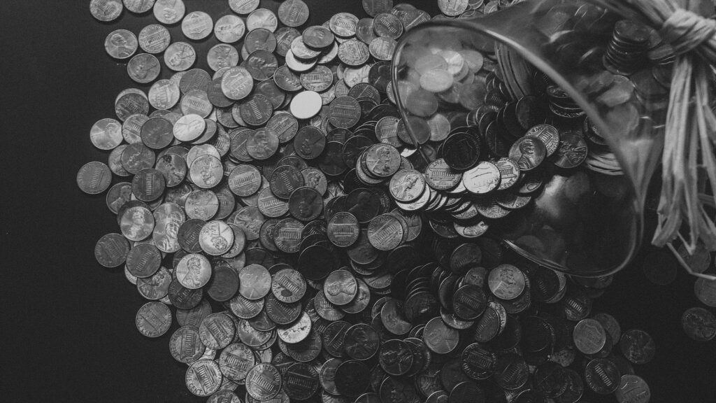 Coins pour out of a cup.