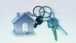 Keys attached to a house-shaped keychain.