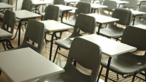 Close-up of chairs and desks in an empty classroom.