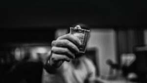 A hand holds up a crumpled $1 dollar bill.