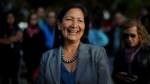A smiling Deb Haaland attends a gathering.