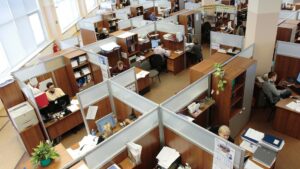 Overhead view of office space, with people working in cublicles.