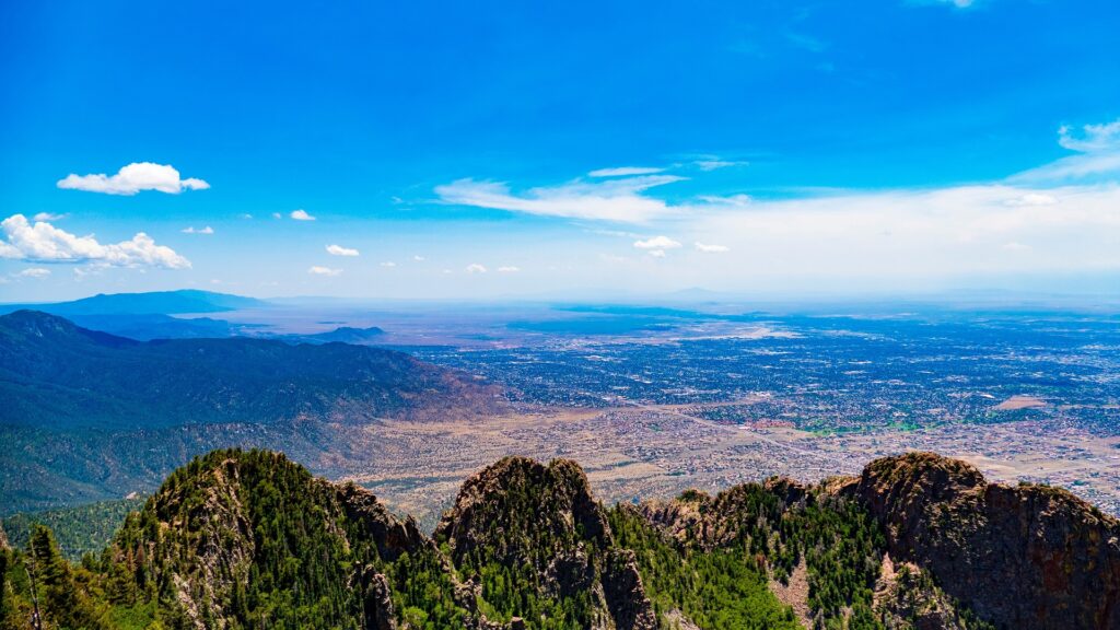 View from the peak of a mountain of a city below.