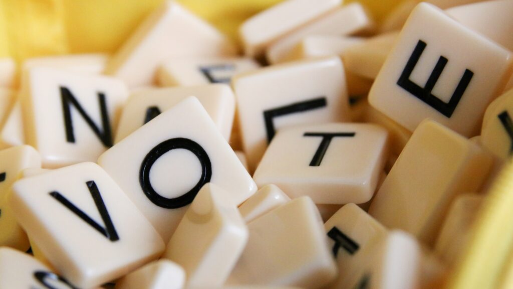 Close-up of Scrabble tiles that read "VOTE".