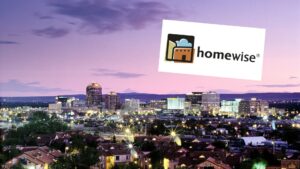 Downtown Albuquerque skyline at evening, with superimposed logo for Homewise.