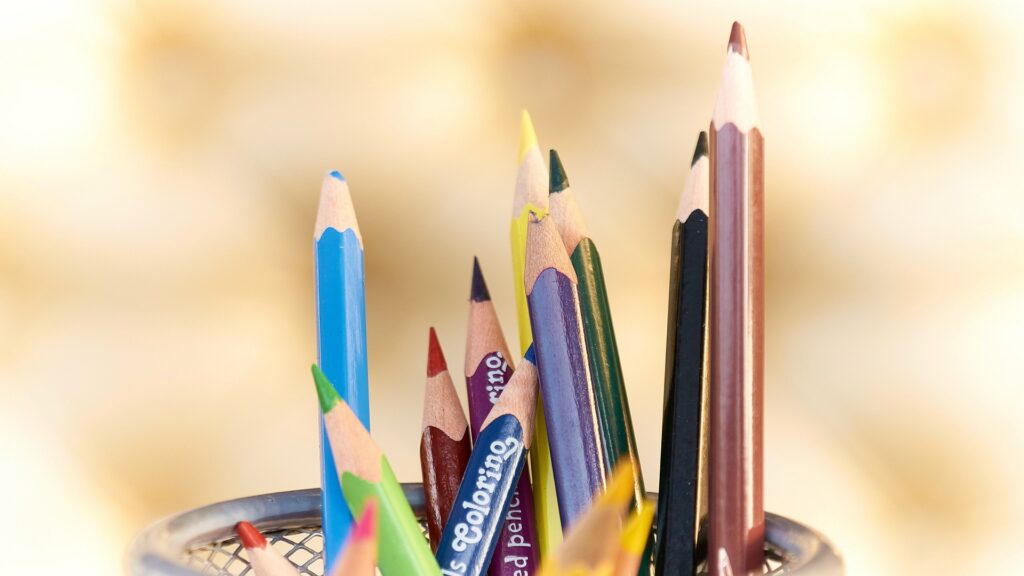 A variety of colored pencils in a cup.