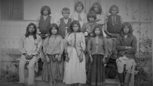 Portrait of a group of young Apache people as they attend a boarding school.