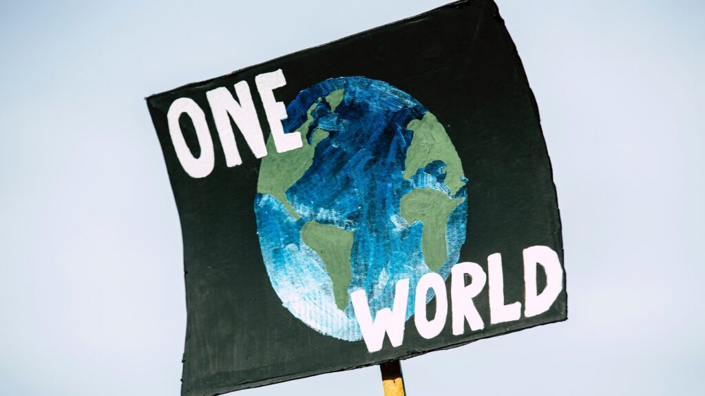A poster with the Earth and "ONE WORLD" painted on it.