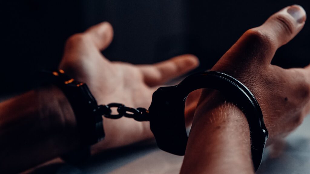 Close-up of hands in handcuffs.
