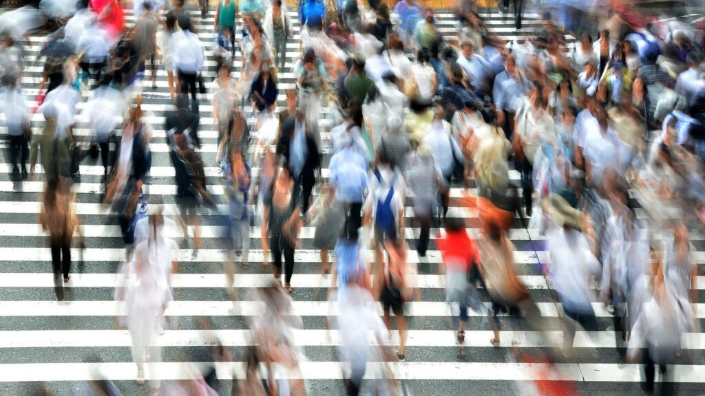 A blurry image of people walking up and down stairs