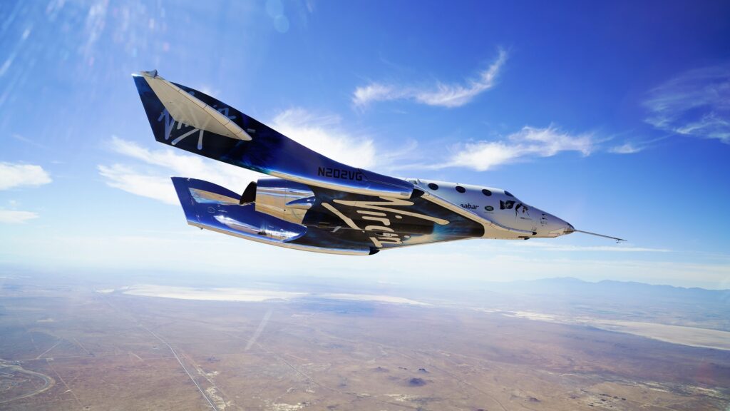 A Virgin Galactic ship glides across the sky.