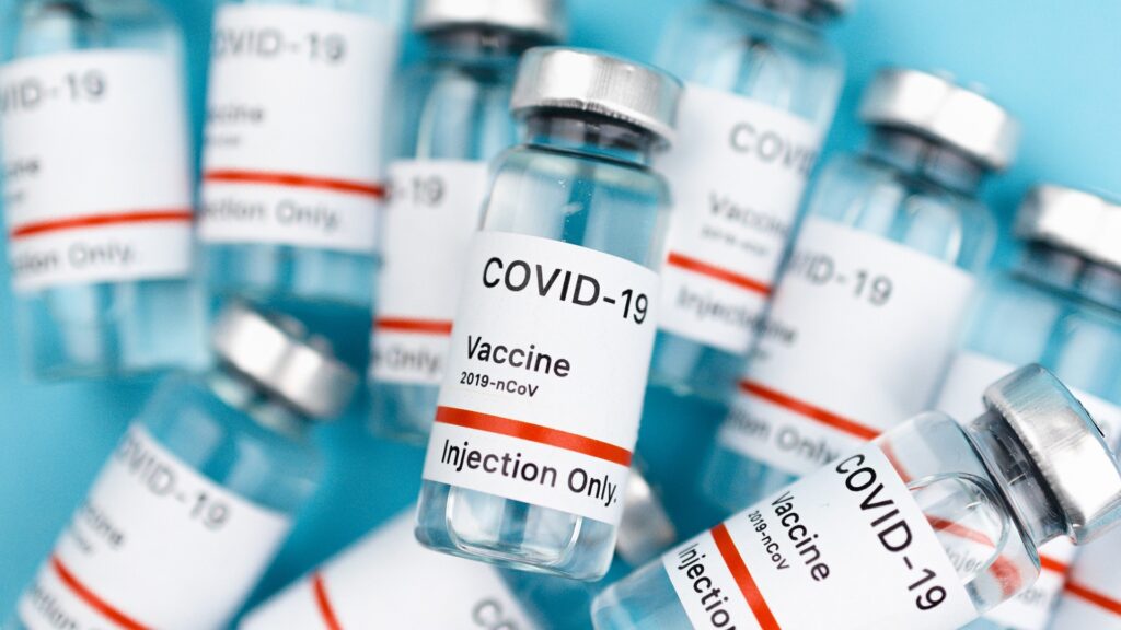 A smattering of vials labeled "COVID-19 Vaccine".