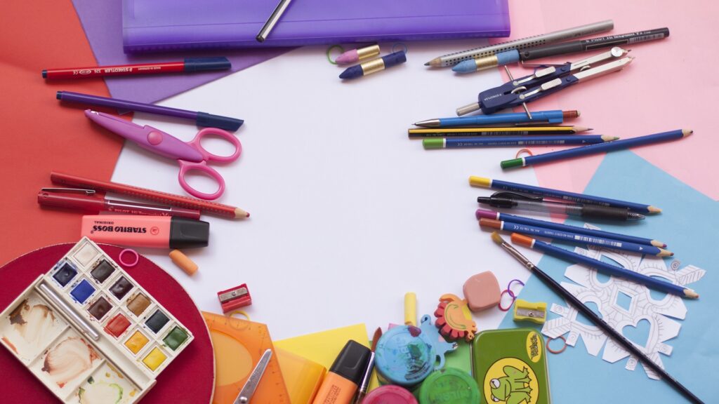 A table with school supplies littered everywhere